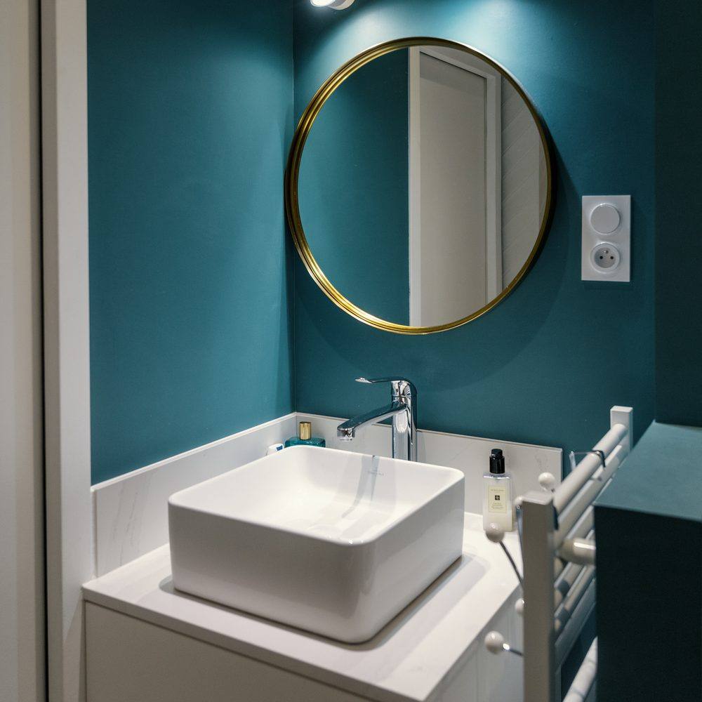 Salle d'eau, miroir doré sur mur canard